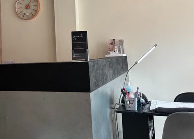 Reception area at Beauty Within, Gosport, England, GB with sleek desk and decor.