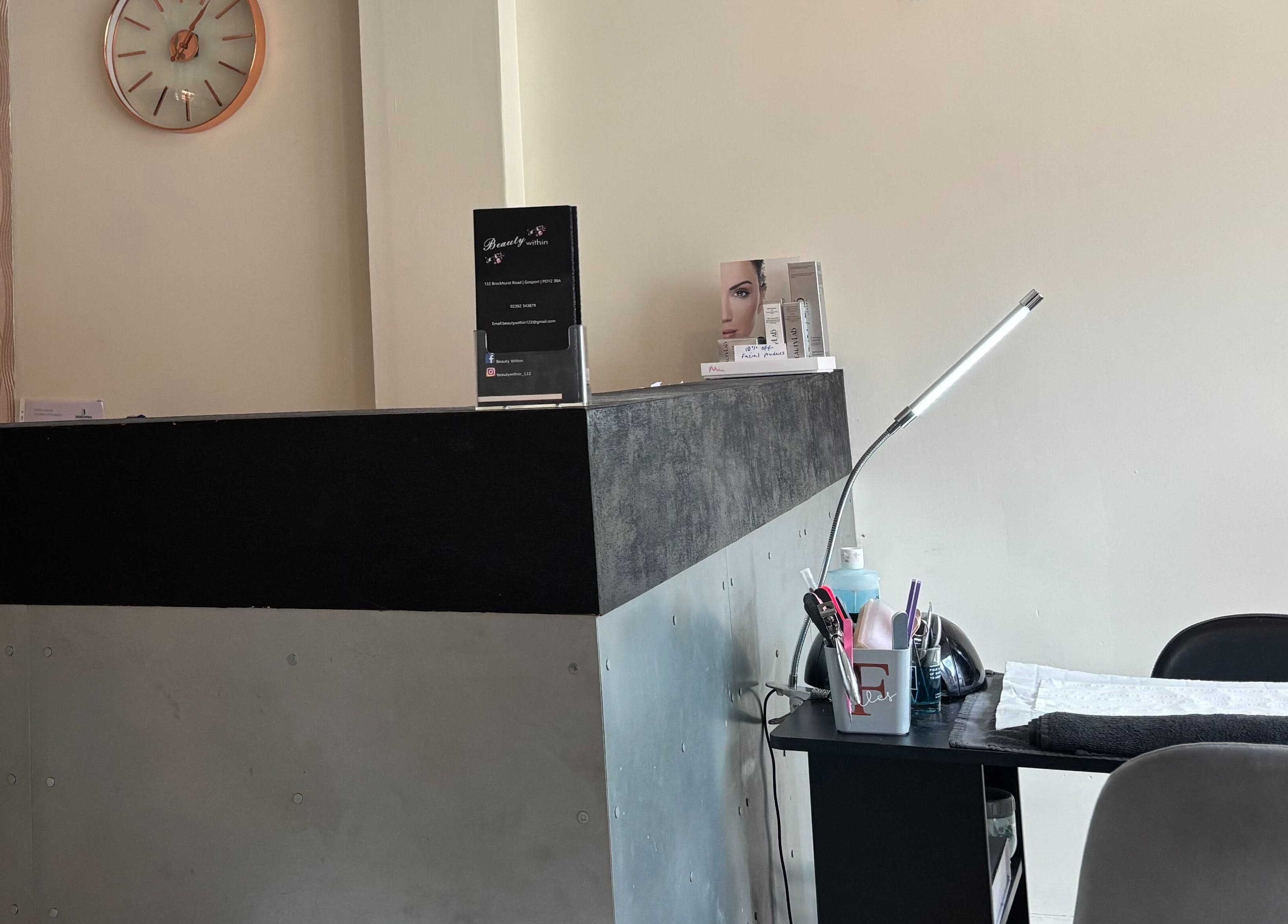 Reception area at Beauty Within, Gosport, England, GB with sleek desk and decor.