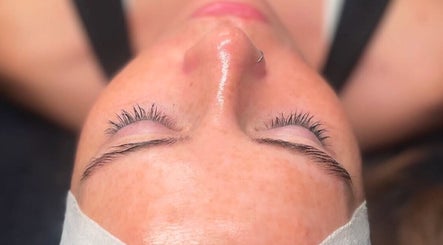 Facial treatment at Rhijuvenate Skin & Healing in Royston, England, GB; client with closed eyes and glowing skin.