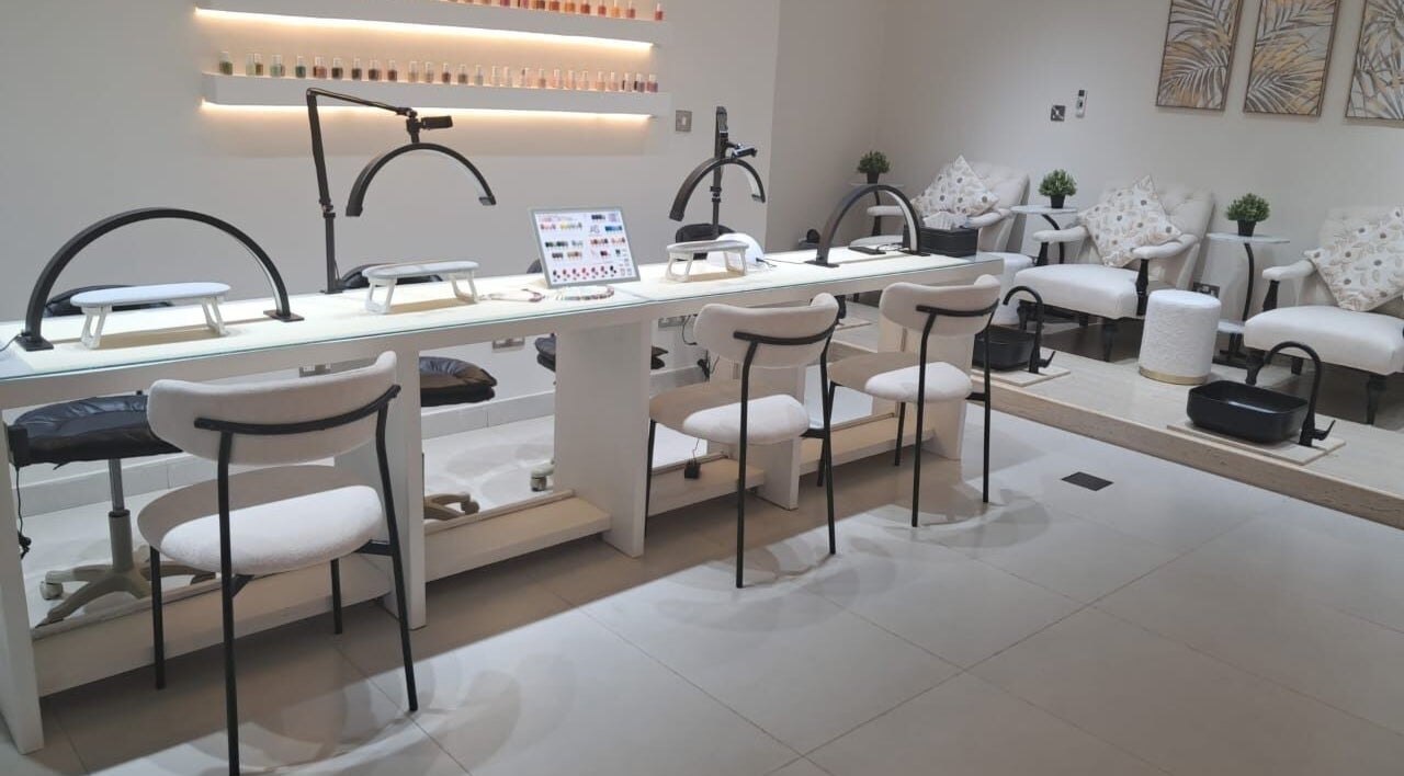 Elegant nail salon at Evano Spa Ladies, Al Ain, Abu Dhabi, AE, featuring chic manicure and pedicure stations.