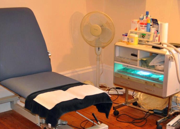 Treatment room at Pods Footcare Specialists with chair and equipment in Beccles, England, GB.