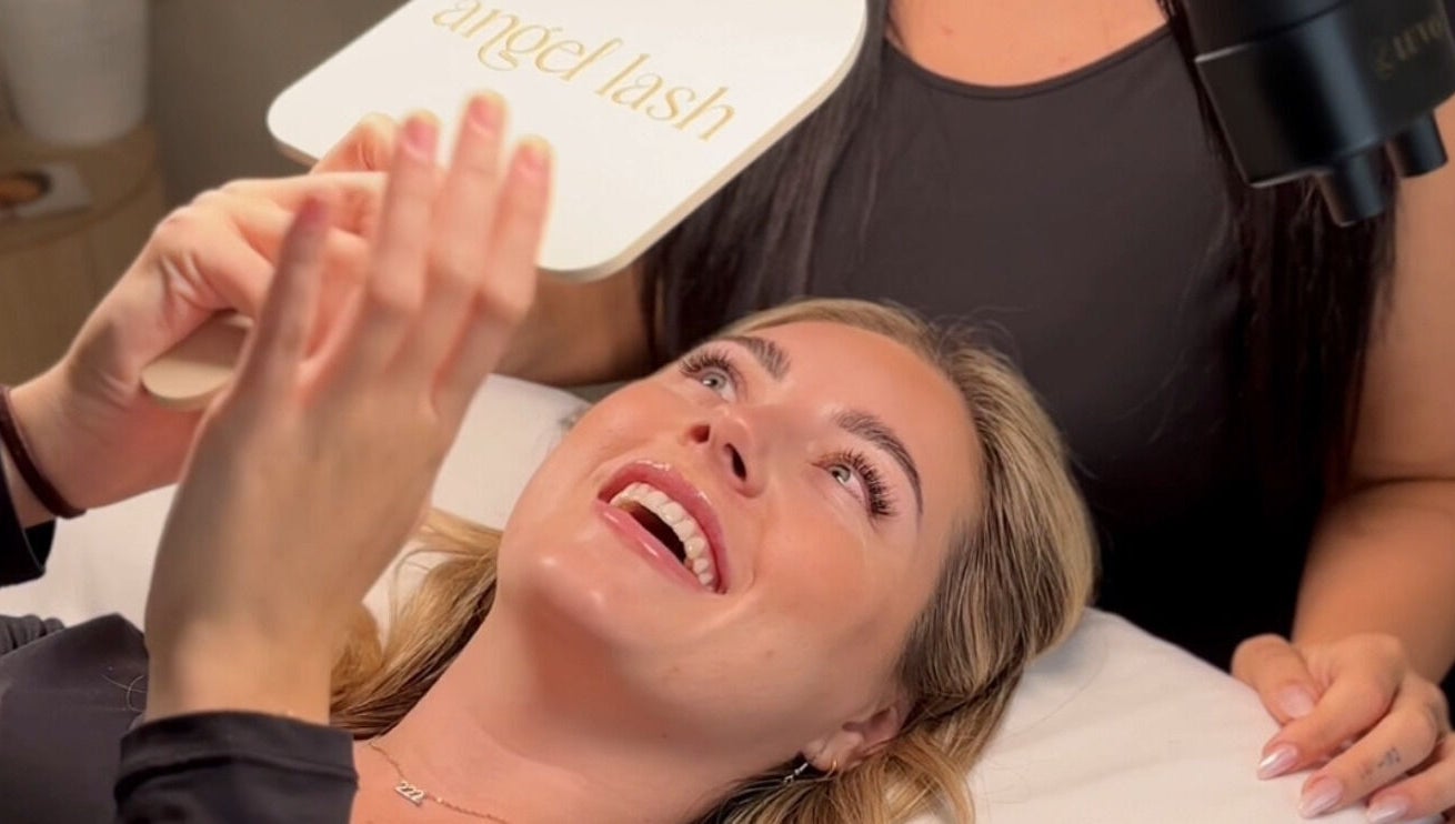 Happy client admires new lashes at Angel Lash, Beaconsfield, Western Australia, AU.