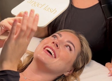 Happy client admires new lashes at Angel Lash, Beaconsfield, Western Australia, AU.