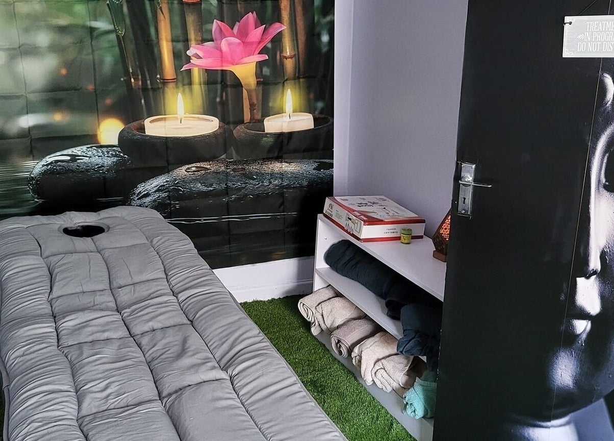 Relaxing massage room at Macroom Massage and Holistic Clinic, County Cork, with candles and serene decor.