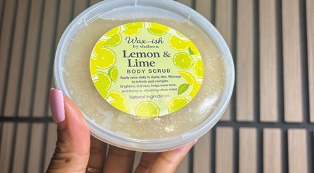 Lemon & Lime Body Scrub by Waxish by Shalawn, Arouca, Tunapuna/Piarco, TT, in a hand-held container.