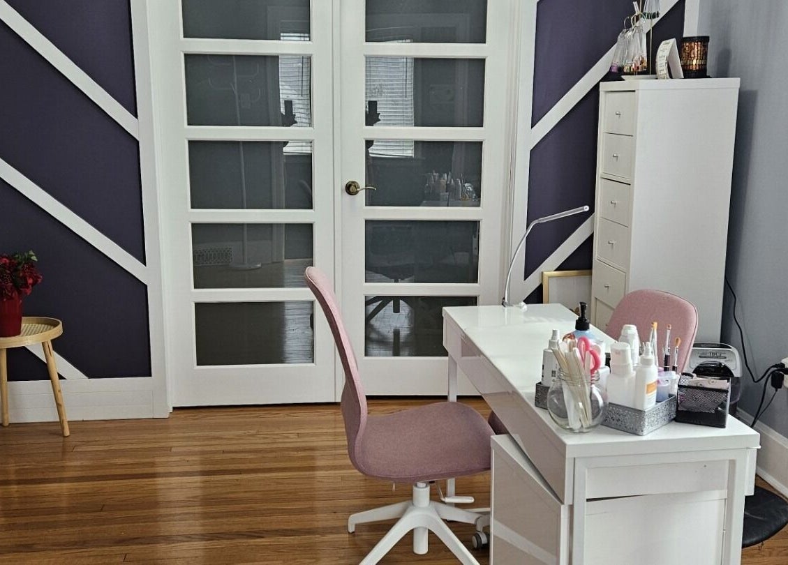 Tranquil spa room at Natera Massage and Esthetics in Winnipeg, Manitoba, CA, featuring a neat desk and cozy chair.
