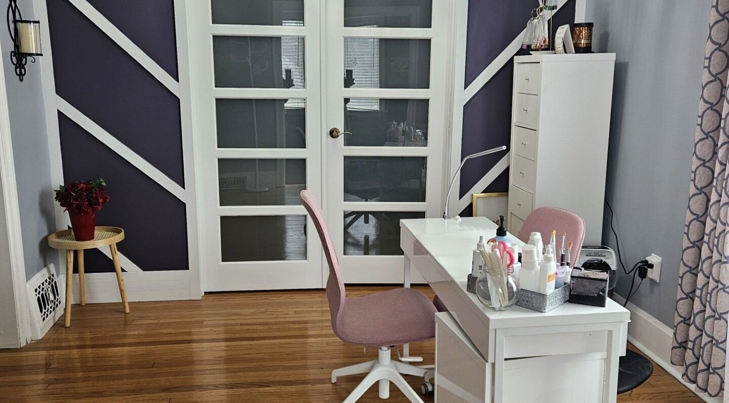 Tranquil spa room at Natera Massage and Esthetics in Winnipeg, Manitoba, CA, featuring a neat desk and cozy chair.