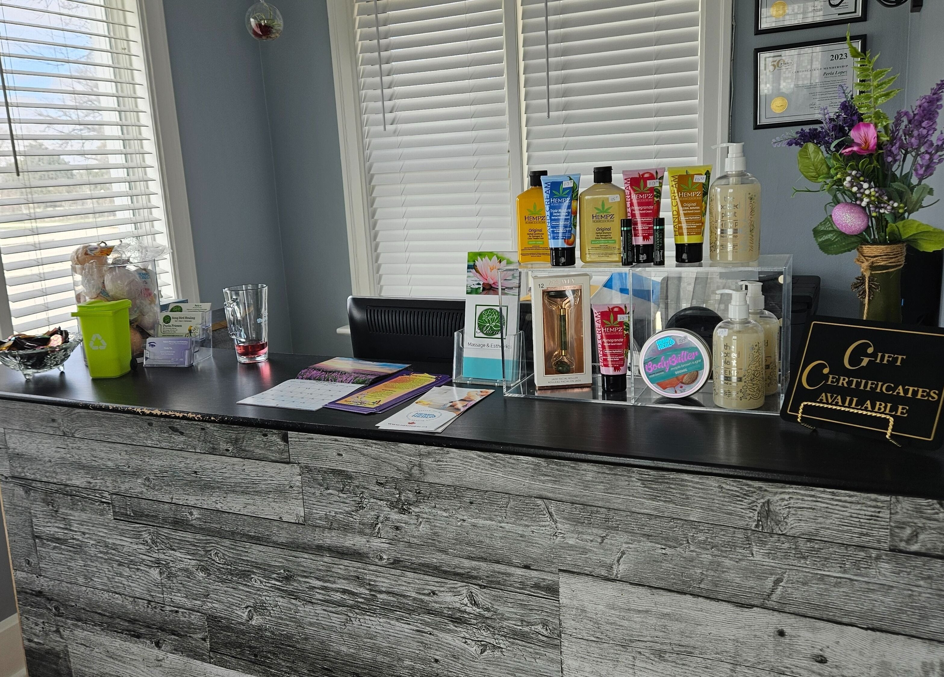 Reception desk at Natera Massage and Esthetics, Winnipeg, Manitoba, CA, with products and gift certificates.