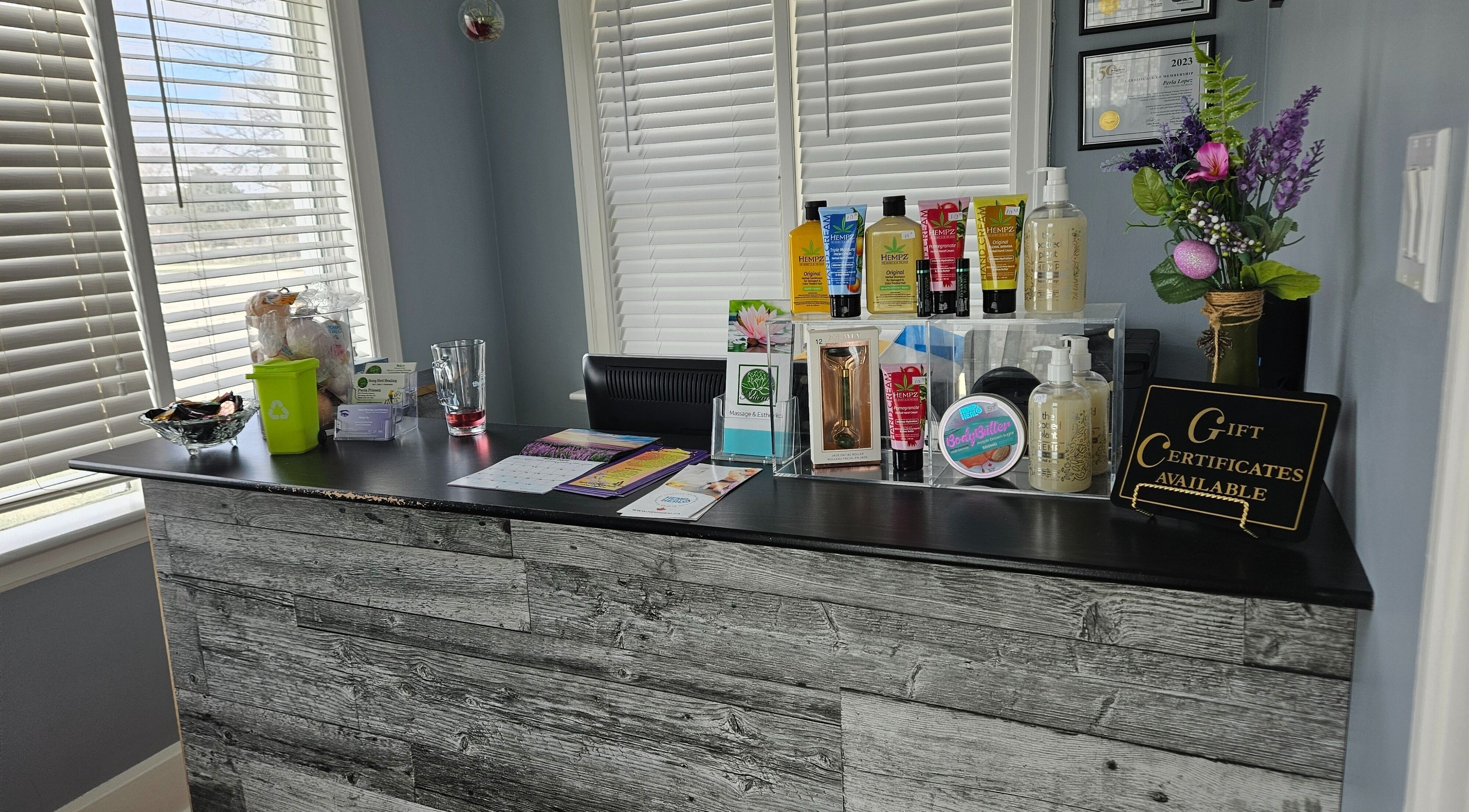 Reception desk at Natera Massage and Esthetics, Winnipeg, Manitoba, CA, with products and gift certificates.