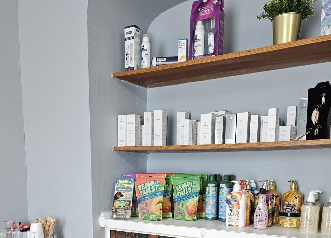 Shelf at Natera Massage and Esthetics in Winnipeg, Manitoba, CA showcasing beauty products and skincare items.