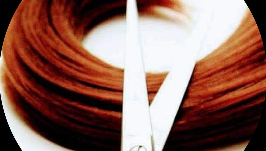 Close-up of hair with scissors at Visona Studio, Dublin, County Dublin, IE, showcasing expert styling tools.