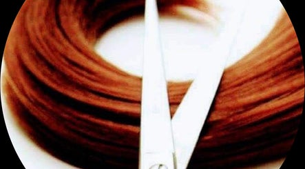 Close-up of hair with scissors at Visona Studio, Dublin, County Dublin, IE, showcasing expert styling tools.