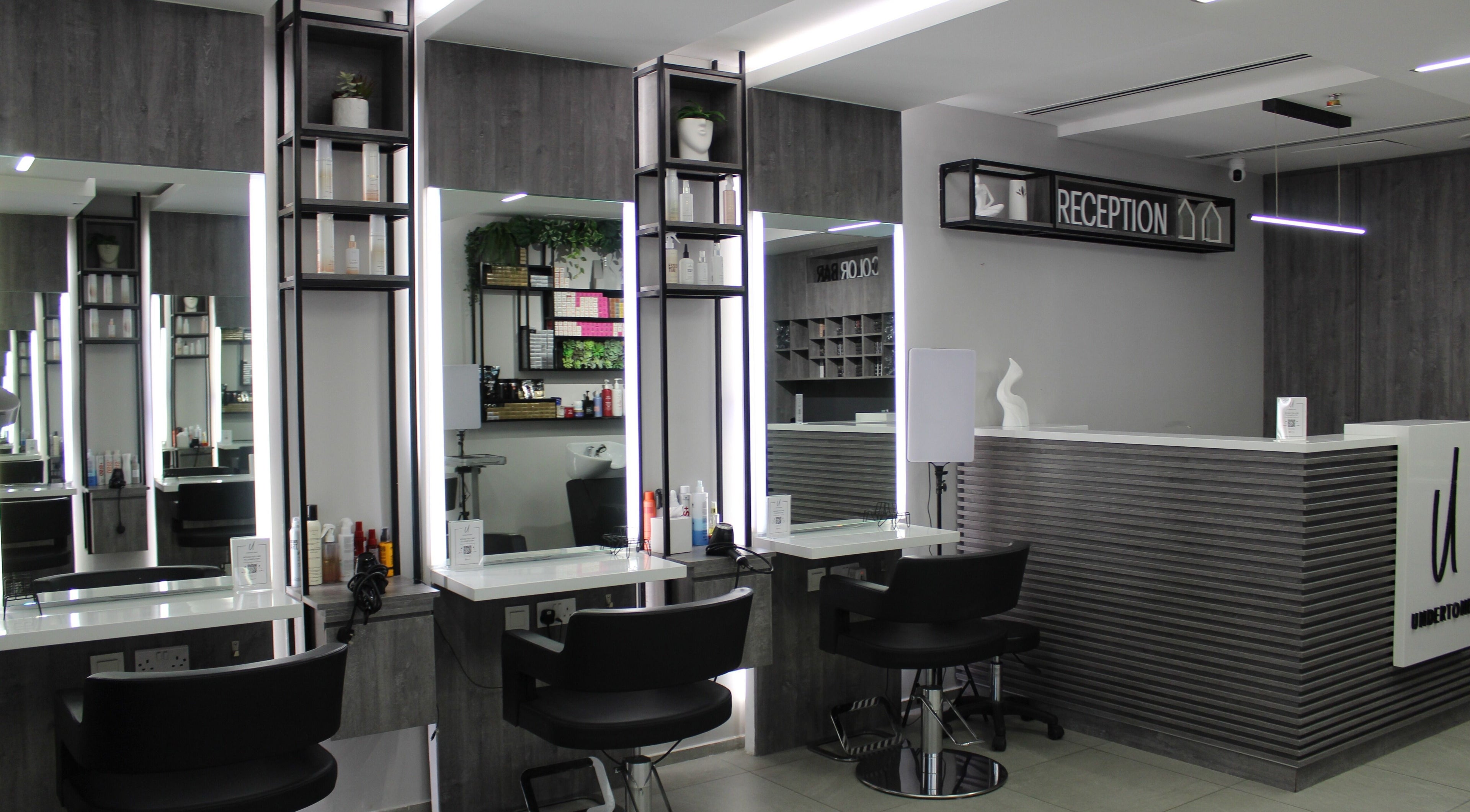 Chic and modern interior of UNDERTONE Hair Salon in Dubai, Dubai, AE, featuring sleek decor and styling stations.