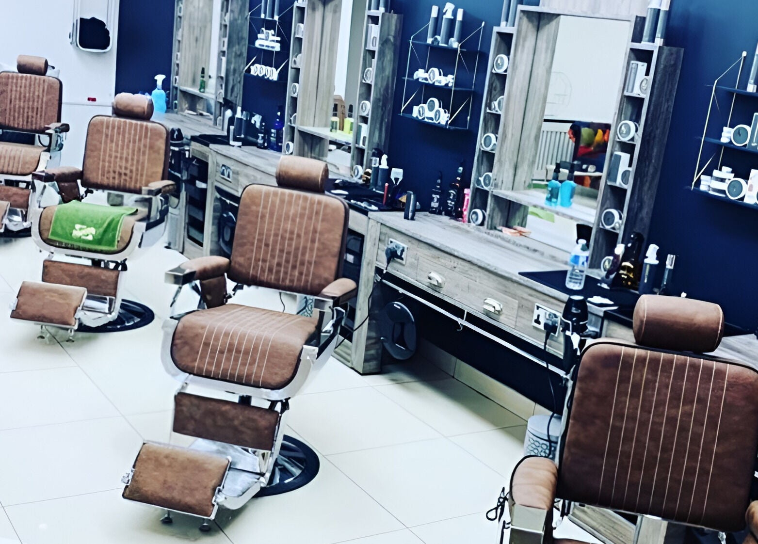 Interior of Le Vogue Barber in Bowdon, England, GB, showcasing sleek, vintage-style barber chairs.