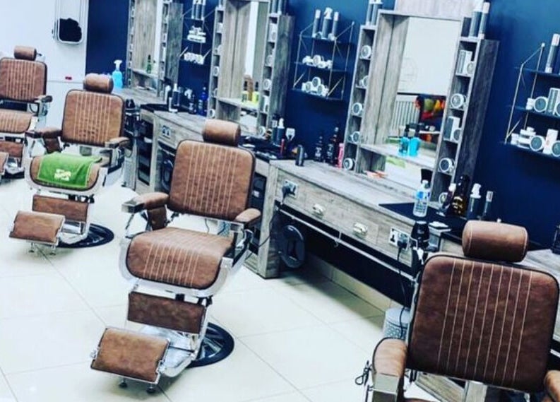 Elegant barber chairs and grooming stations at Le Vogue Barber in Bowdon, England, GB.