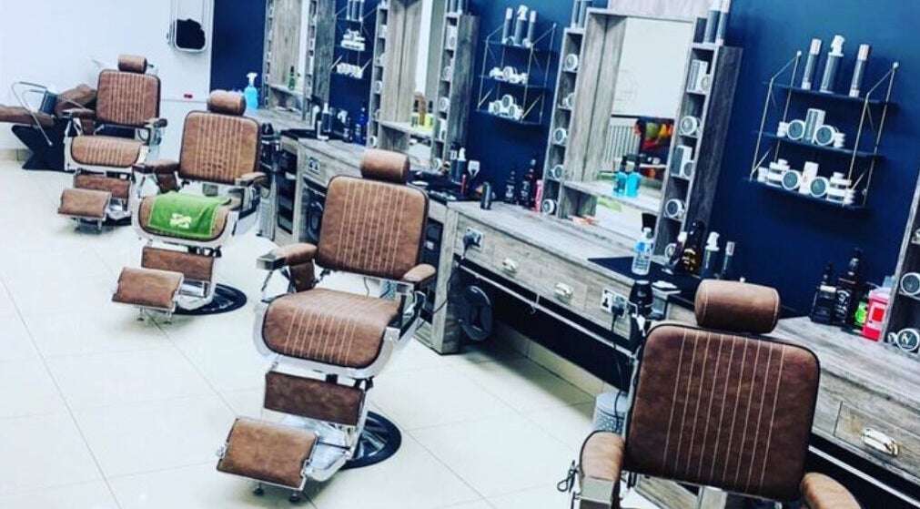 Elegant barber chairs and grooming stations at Le Vogue Barber in Bowdon, England, GB.