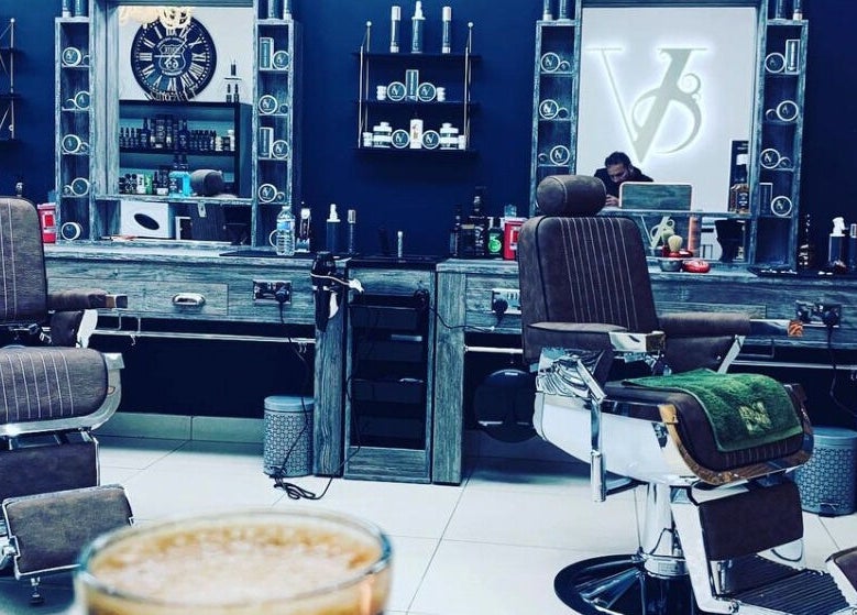 Elegant interior of Le Vogue Barber in Bowdon, England, GB featuring stylish barber chairs and decor.