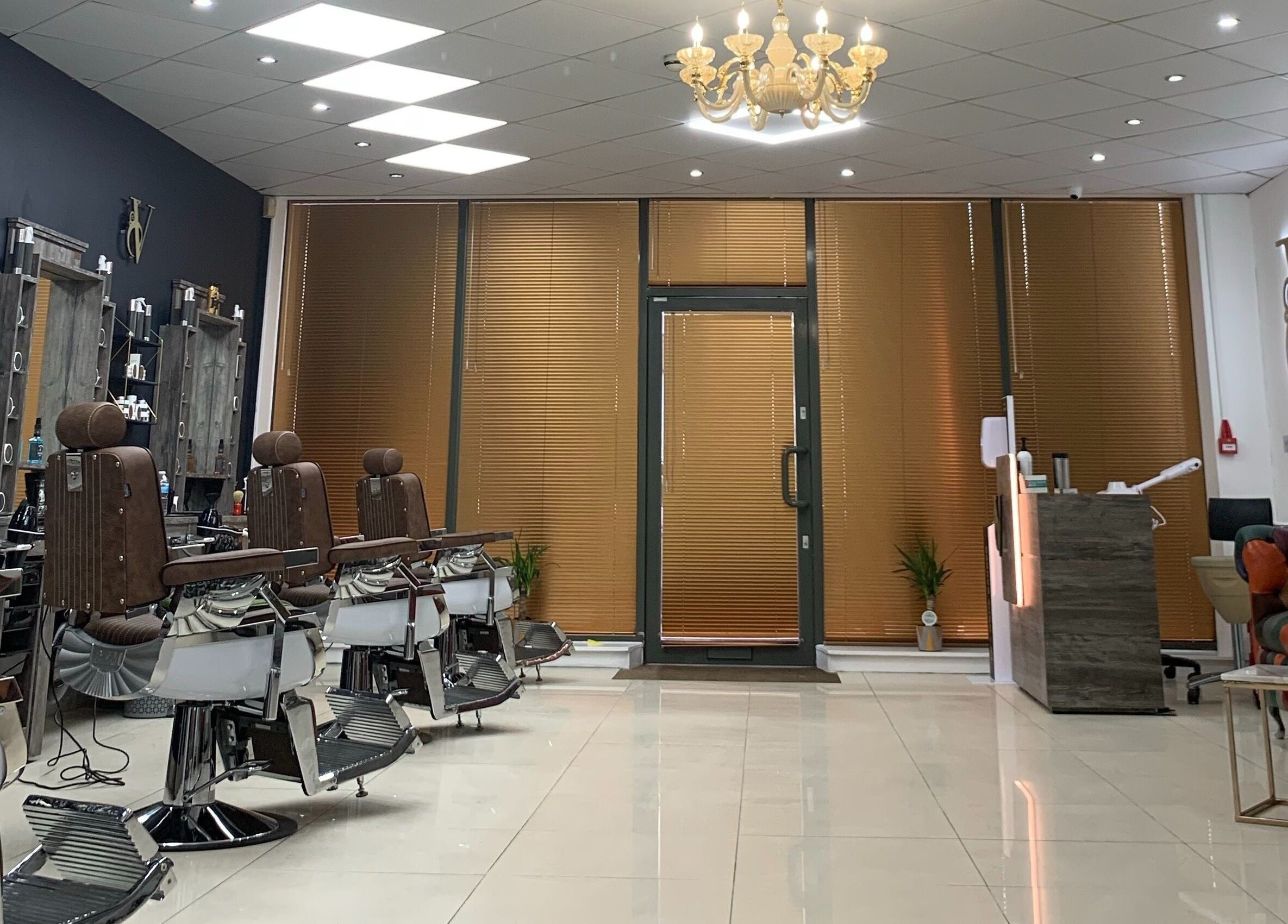 Interior view of Le Vogue Barber in Bowdon, England, GB with stylish barber chairs and chic decor.
