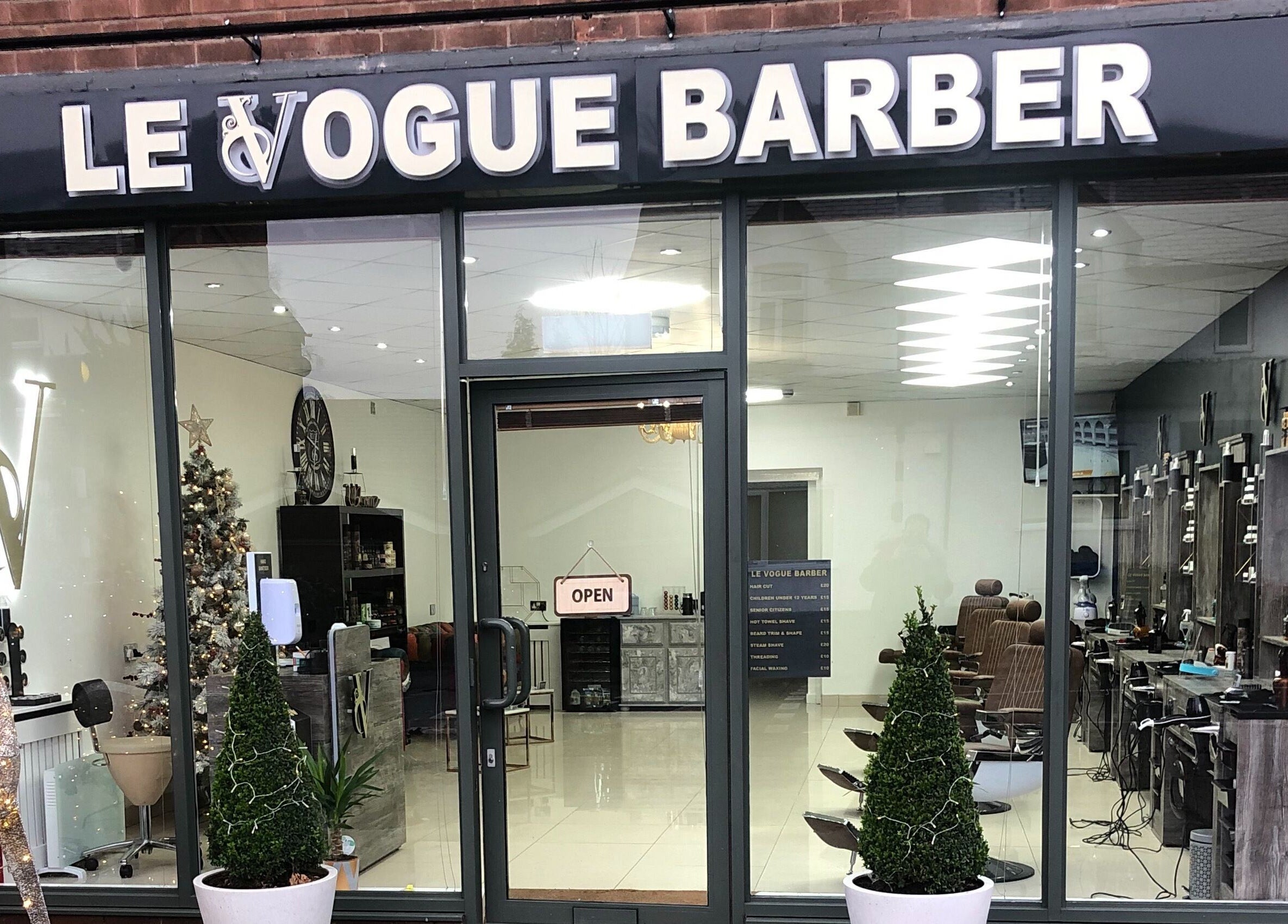 Exterior view of Le Vogue Barber, Bowdon, England, GB with modern decor and welcoming atmosphere.