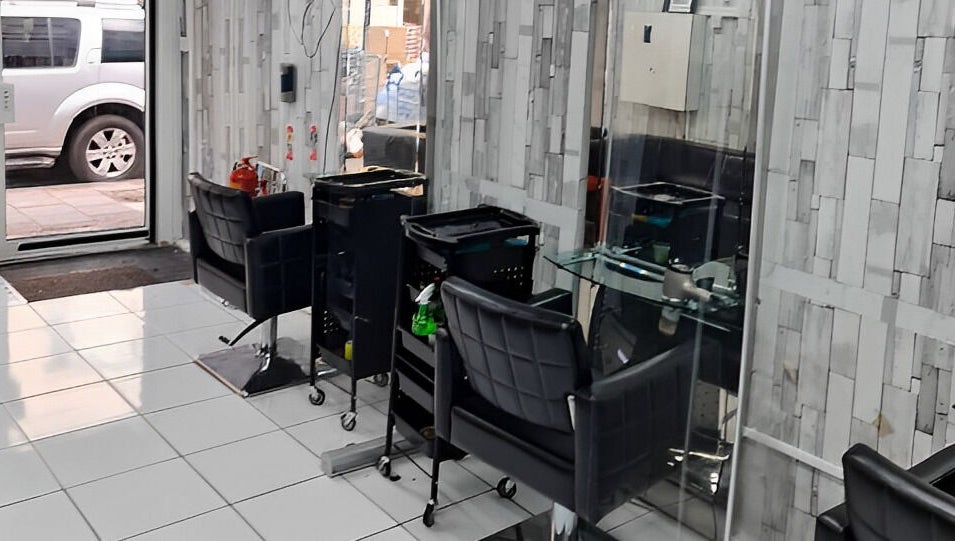 Modern salon interior at Adiscolocstylist, Peckham, United Kingdom, GB, featuring stylish chairs and mirrors.