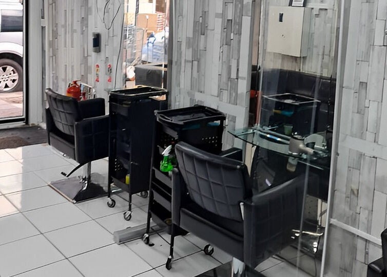 Modern salon interior at Adiscolocstylist, Peckham, United Kingdom, GB, featuring stylish chairs and mirrors.