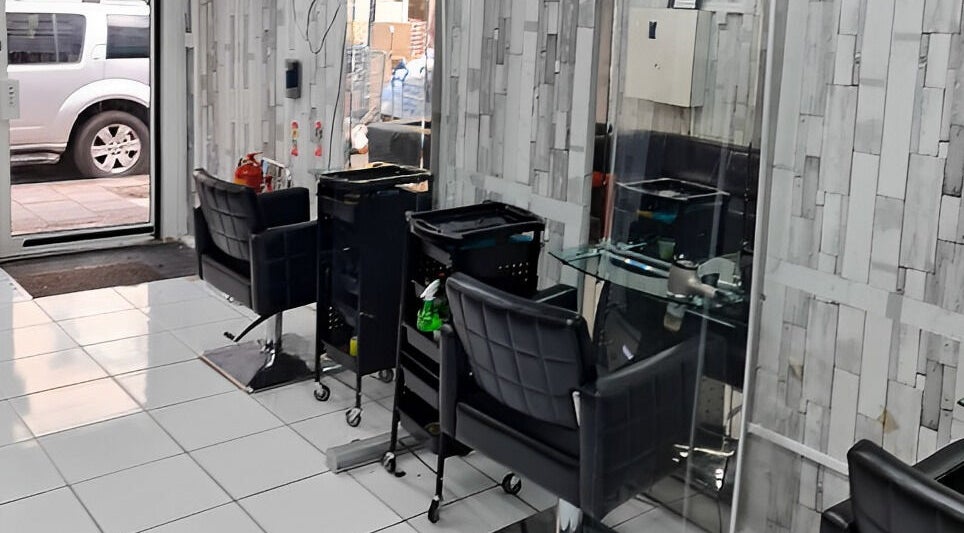 Modern salon interior at Adiscolocstylist, Peckham, United Kingdom, GB, featuring stylish chairs and mirrors.