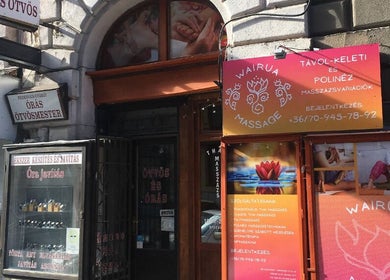 Front of Wairua Thai Masszazs Szalon in Budapest, Magyar, HU with colorful signage and massage images.
