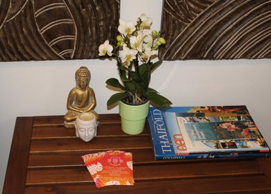 Peaceful corner at Wairua Thai Masszazs Szalon, Budapest, Magyar, HU with a potted orchid and Buddha statue.