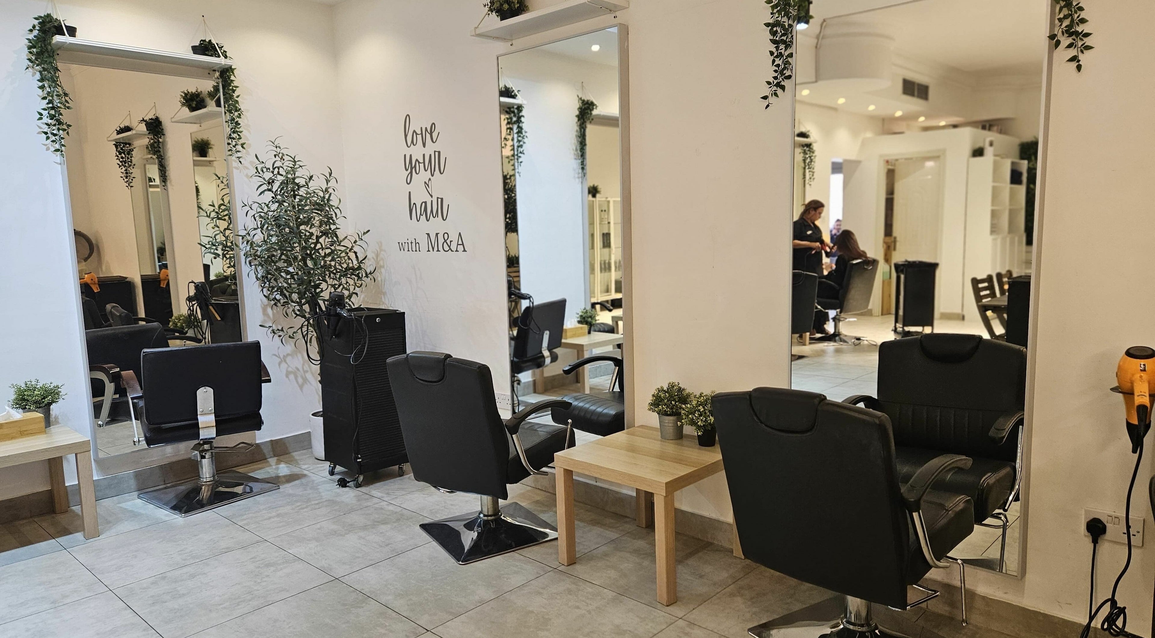 Modern hair salon interior at M&A Beauty Center, Dubai, Dubai, AE, with stylish decor and salon chairs.