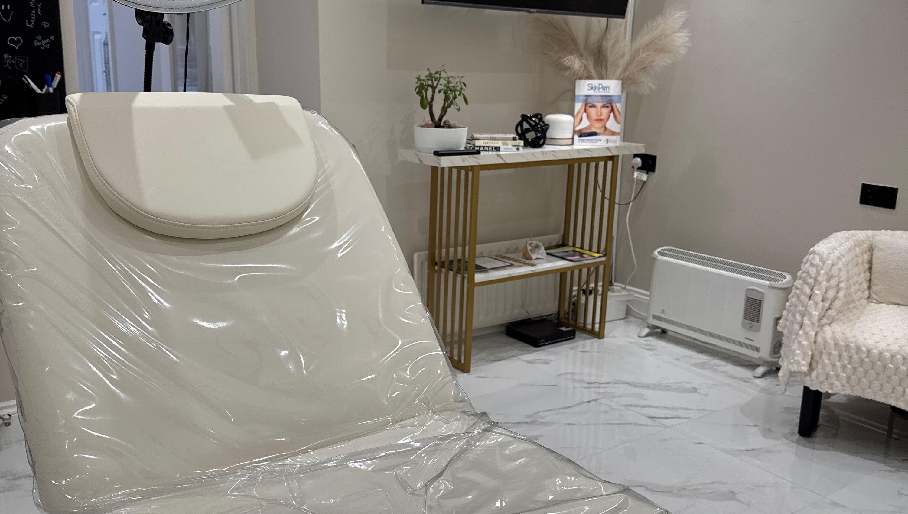 Relaxing treatment room at Mood Skin and Aesthetics in London, England, GB showcasing a serene, elegant design.