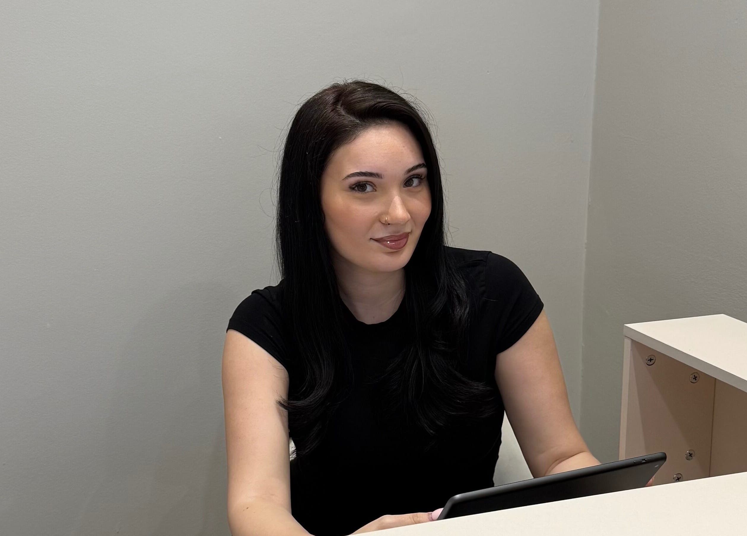 Receptionist with tablet at Mood Skin and Aesthetics, London, England, GB.