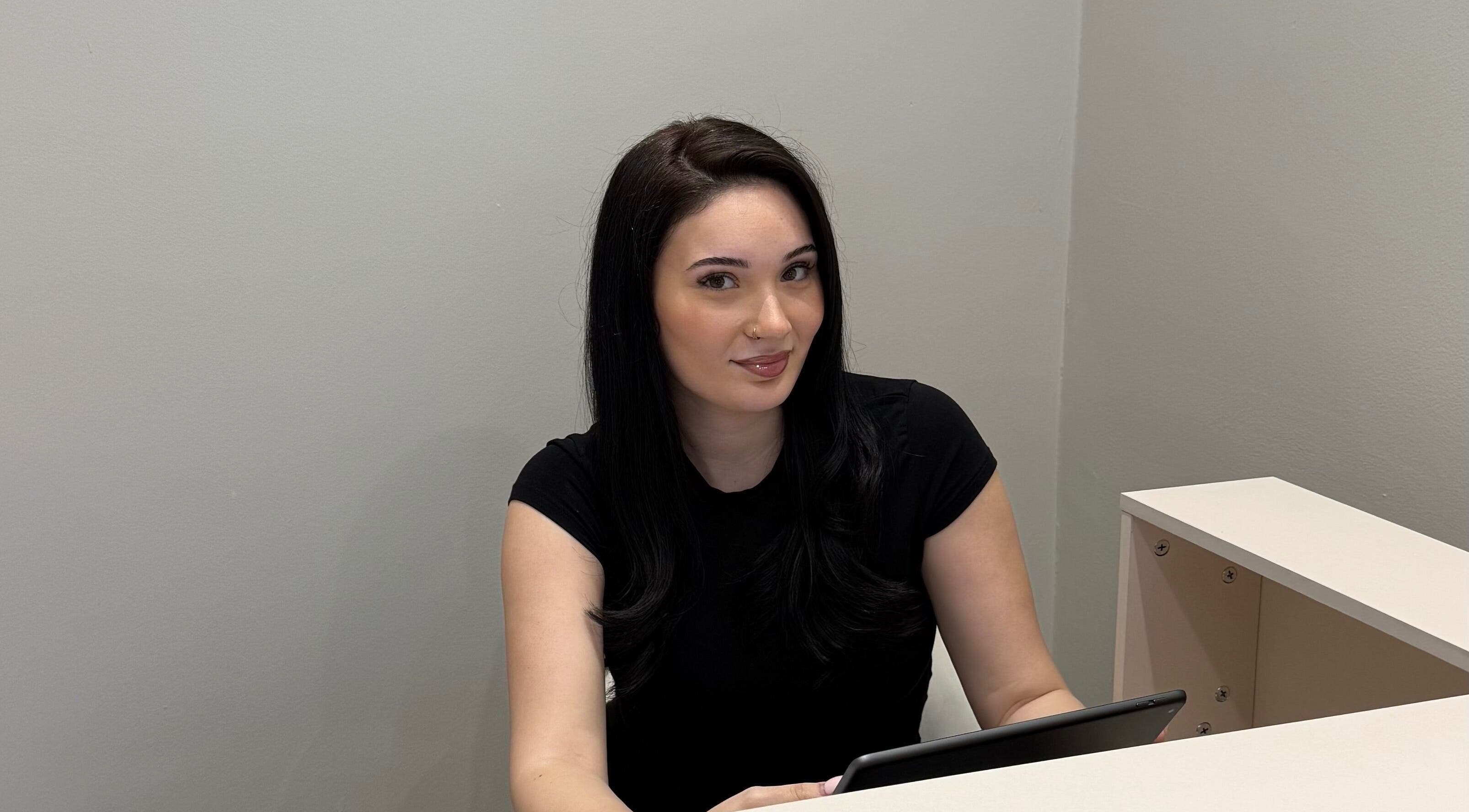 Receptionist with tablet at Mood Skin and Aesthetics, London, England, GB.