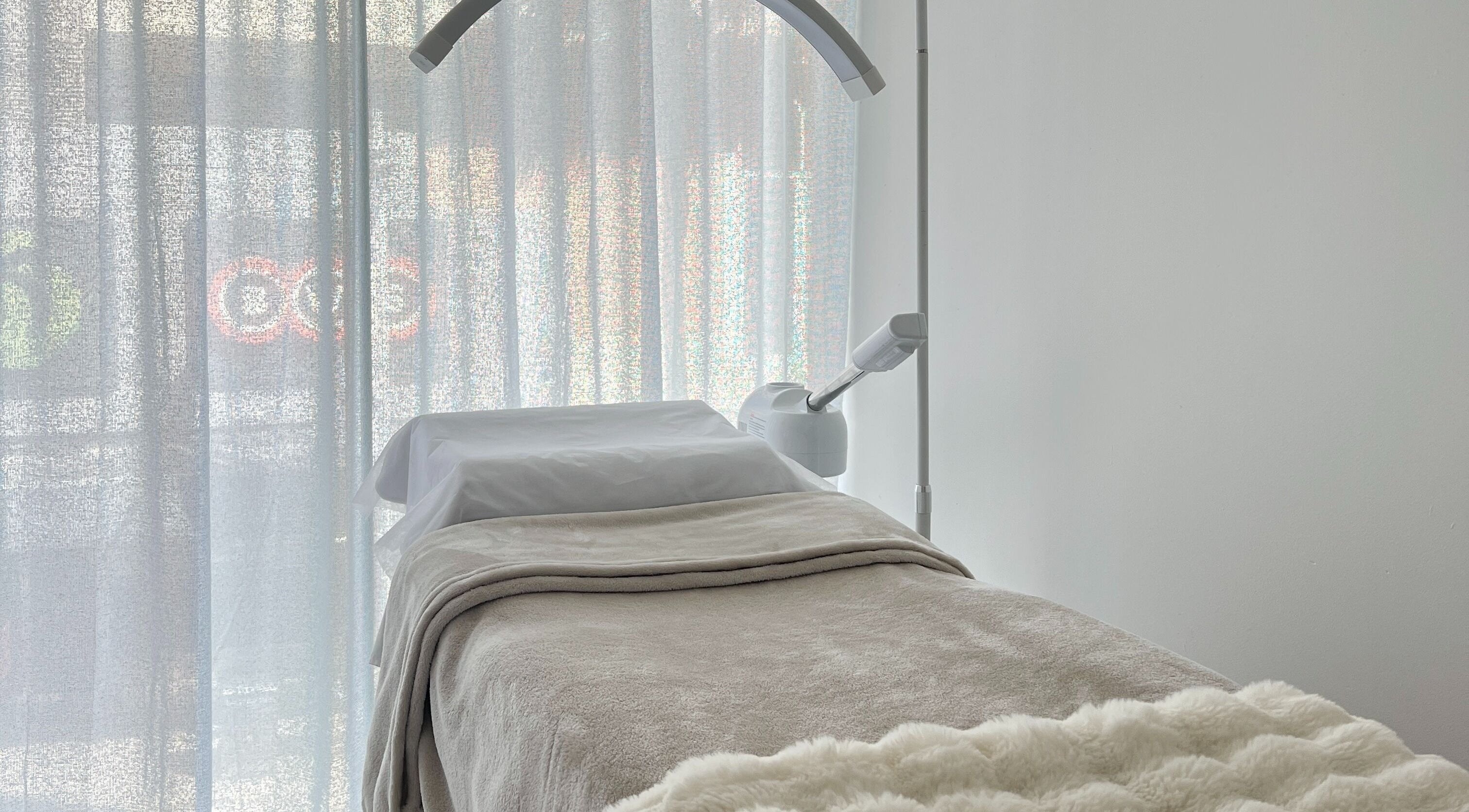 Luxurious treatment room at Yume Aesthetics, Burwood, New South Wales, AU, featuring a cozy bed and soft lighting.