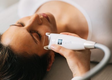 Woman receiving facial treatment at Saunapod, Falmouth, England, GB, enhancing wellness and beauty.