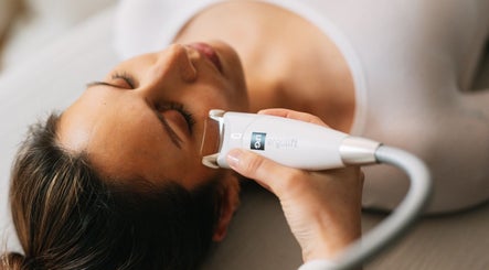 Woman receiving facial treatment at Saunapod, Falmouth, England, GB, enhancing wellness and beauty.
