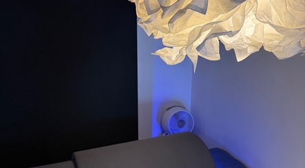 SAUNAPOD in Falmouth, England, GB features a serene room with artistic lighting and calming atmosphere.