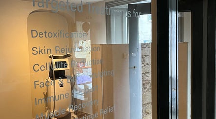 Treatment room at SAUNAPOD in Falmouth, England highlighting modern wellness equipment.