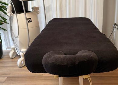 Comfortable massage table at Saunapod, Falmouth, England, GB, ready for a soothing wellness experience.
