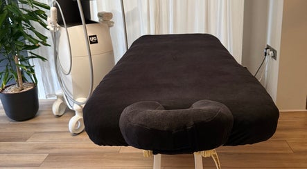 Comfortable massage table at Saunapod, Falmouth, England, GB, ready for a soothing wellness experience.