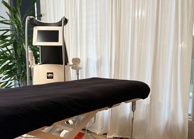A serene treatment room at Saunapod, Falmouth, England, GB, featuring an LPG machine and a comfortable treatment bed.