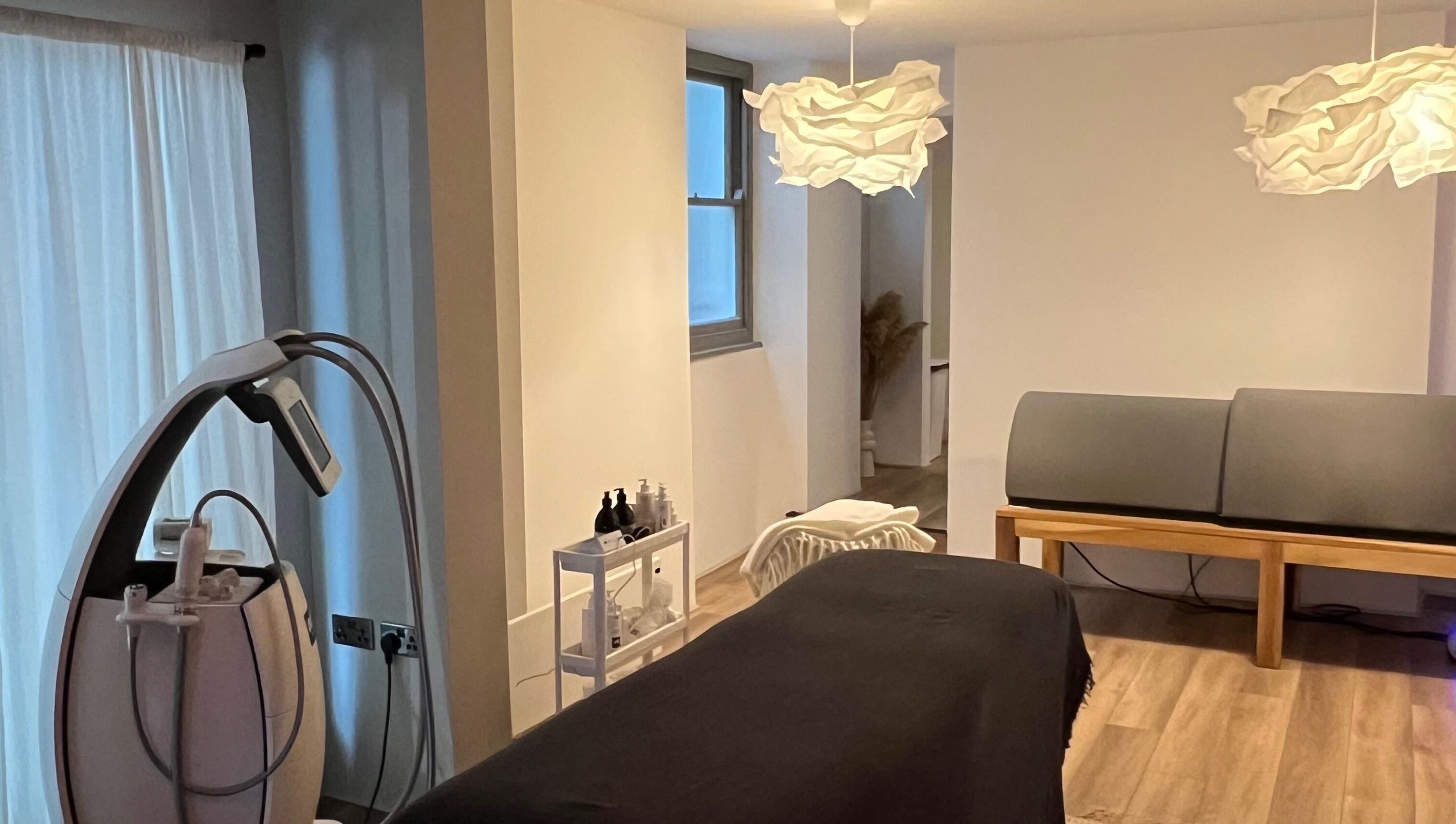 Modern wellness room at Saunapod, Falmouth, England, GB, with treatment table and cozy decor.