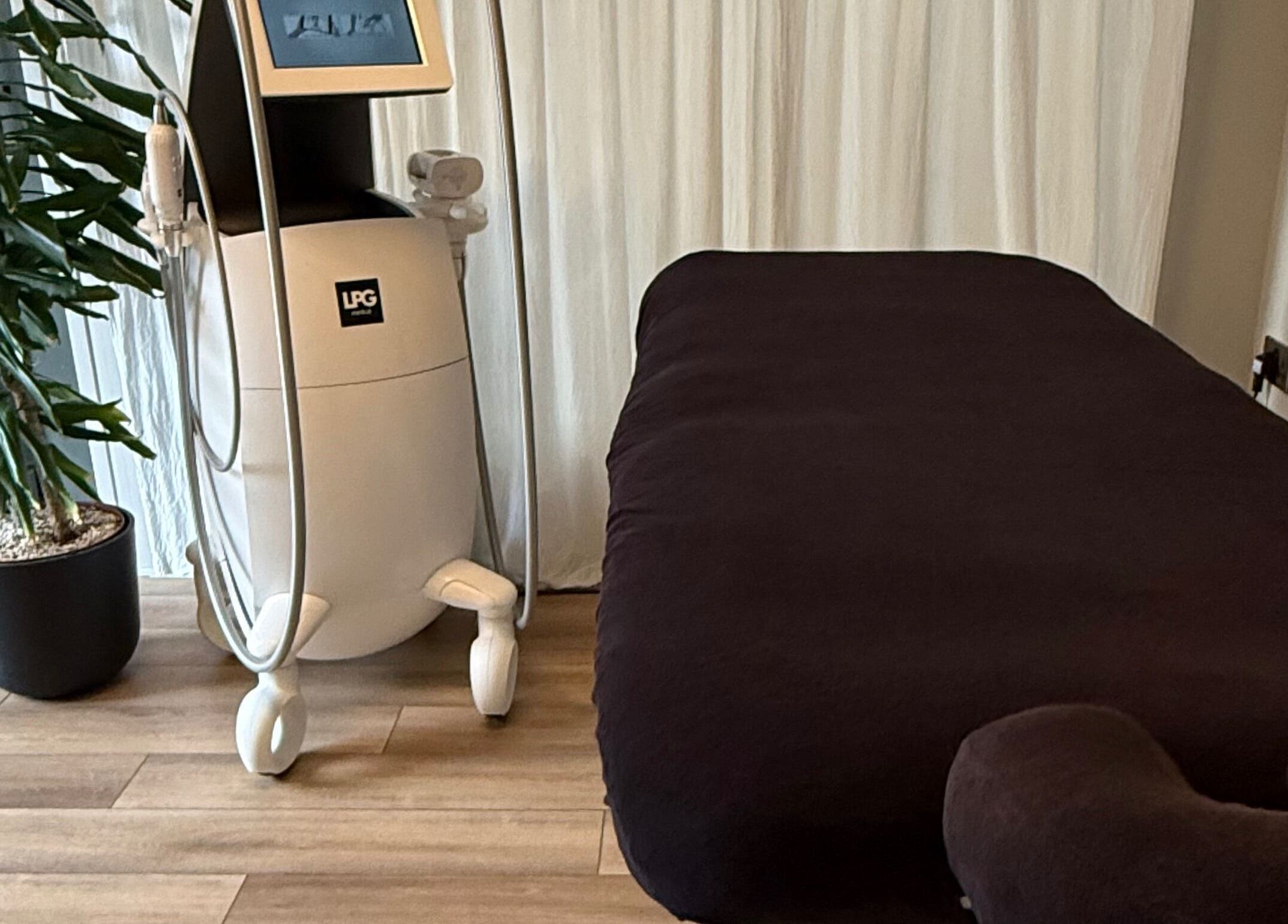 Cozy treatment room in Saunapod, Falmouth, England, GB with modern equipment and lush plant.