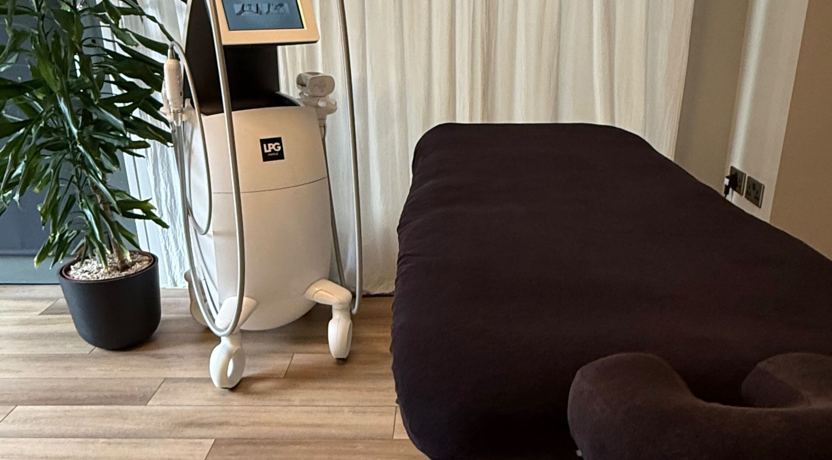 Cozy treatment room in Saunapod, Falmouth, England, GB with modern equipment and lush plant.