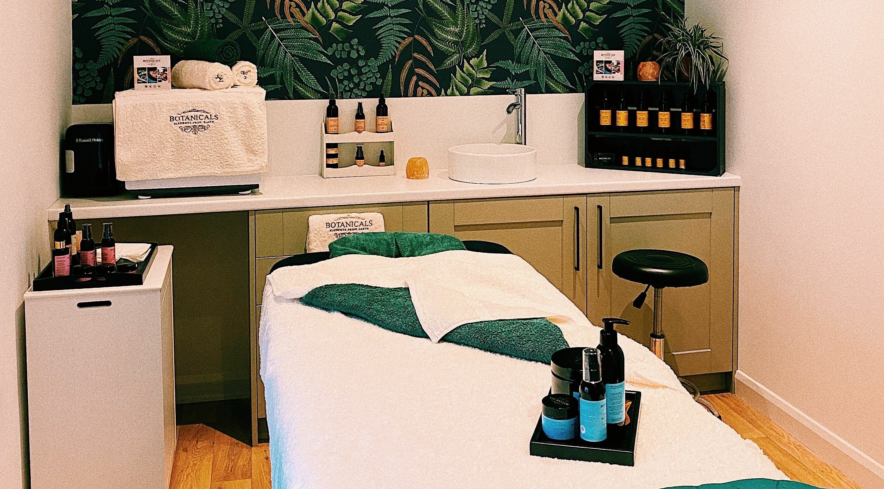 Relaxing treatment room at Botanicals Bakewell, Bakewell, England, GB with a massage bed and natural products.