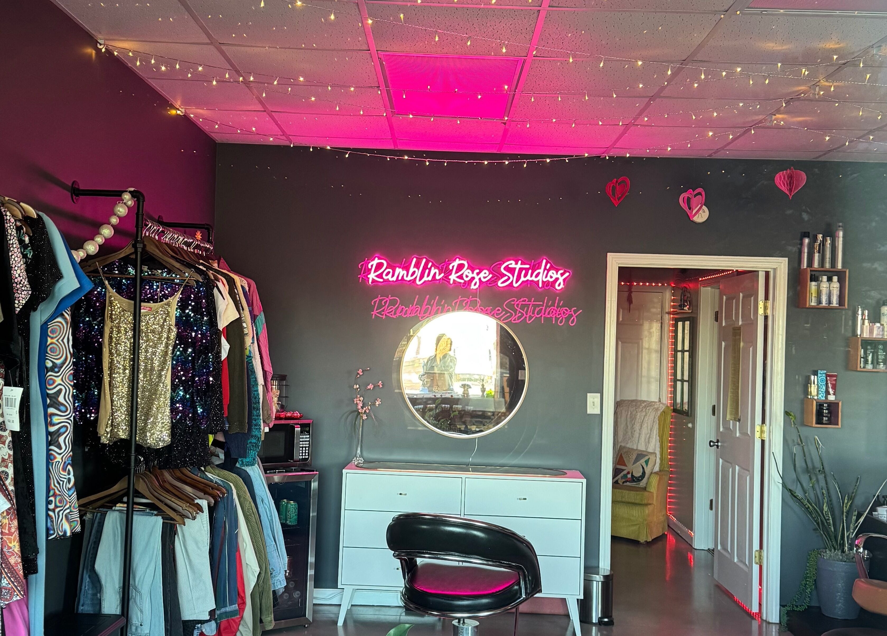 Interior of Ramblin’ Rose Studios in Anderson, SC, featuring stylish decor and a neon sign.