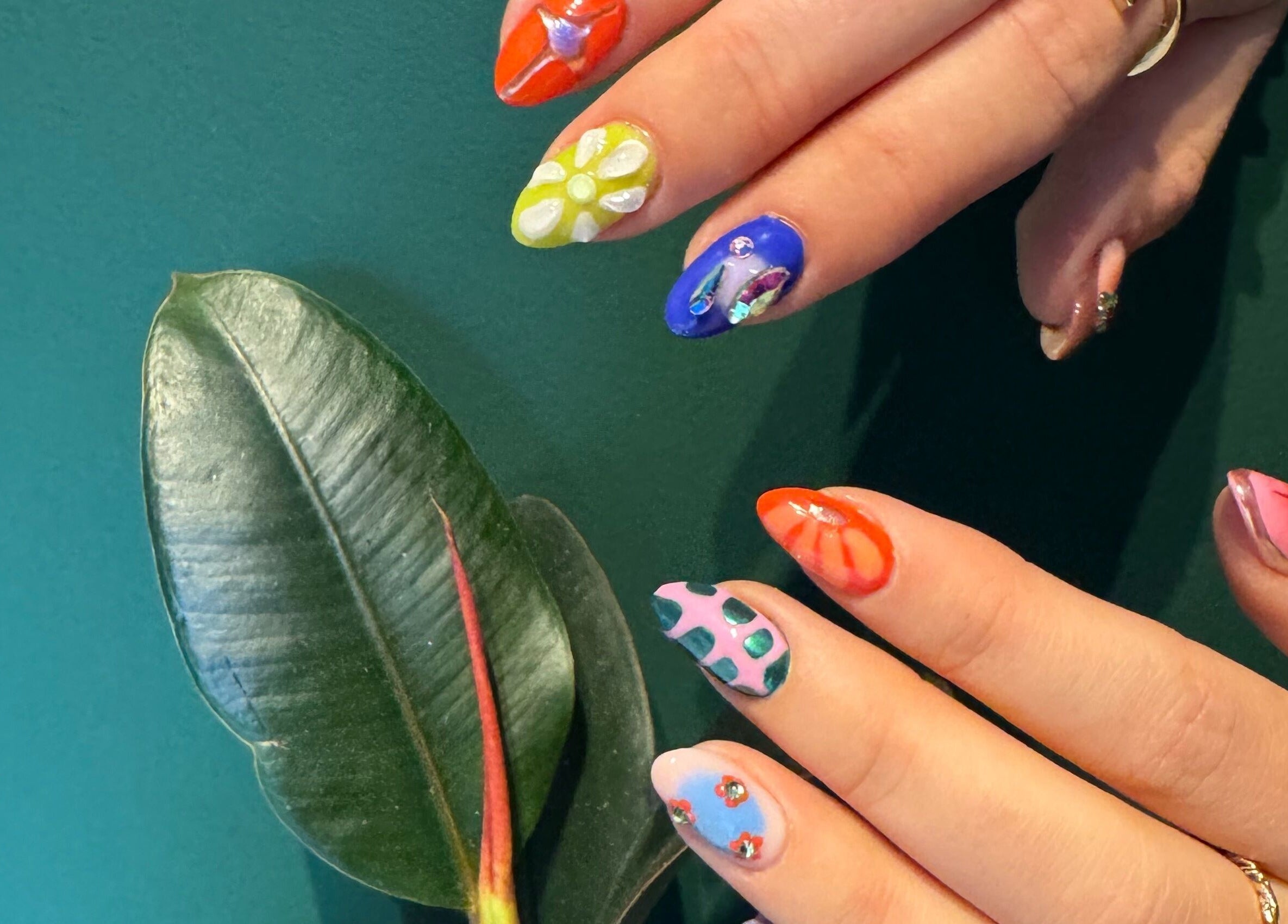 Vibrant floral nail art at Thrive Studio, London, England, GB, showcasing colorful designs.