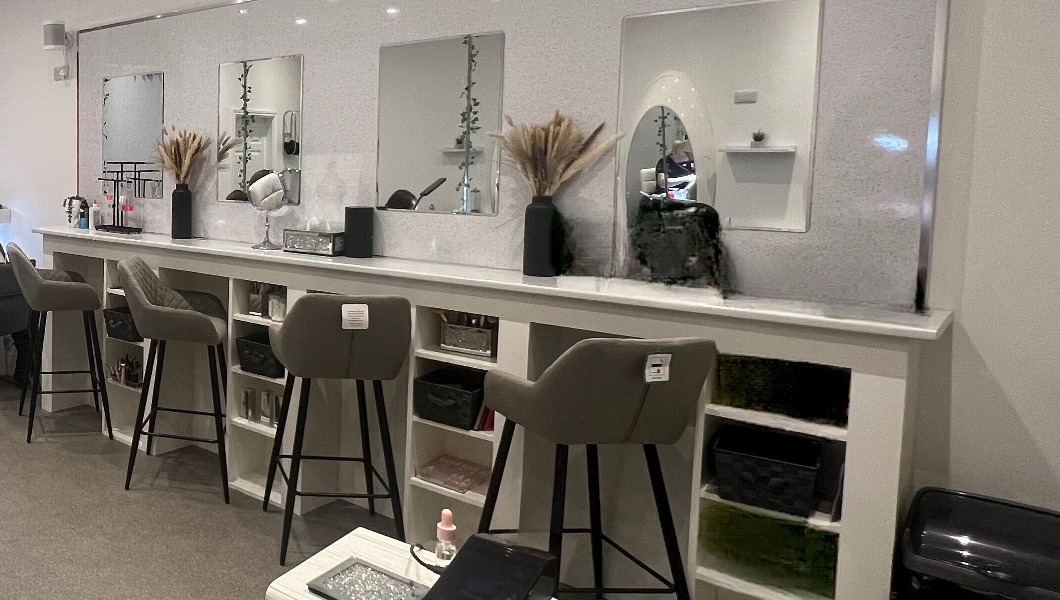 Chic beauty stations at Elysium Beauty Limited, Castletown, GB, featuring stylish mirrors and plush seating.