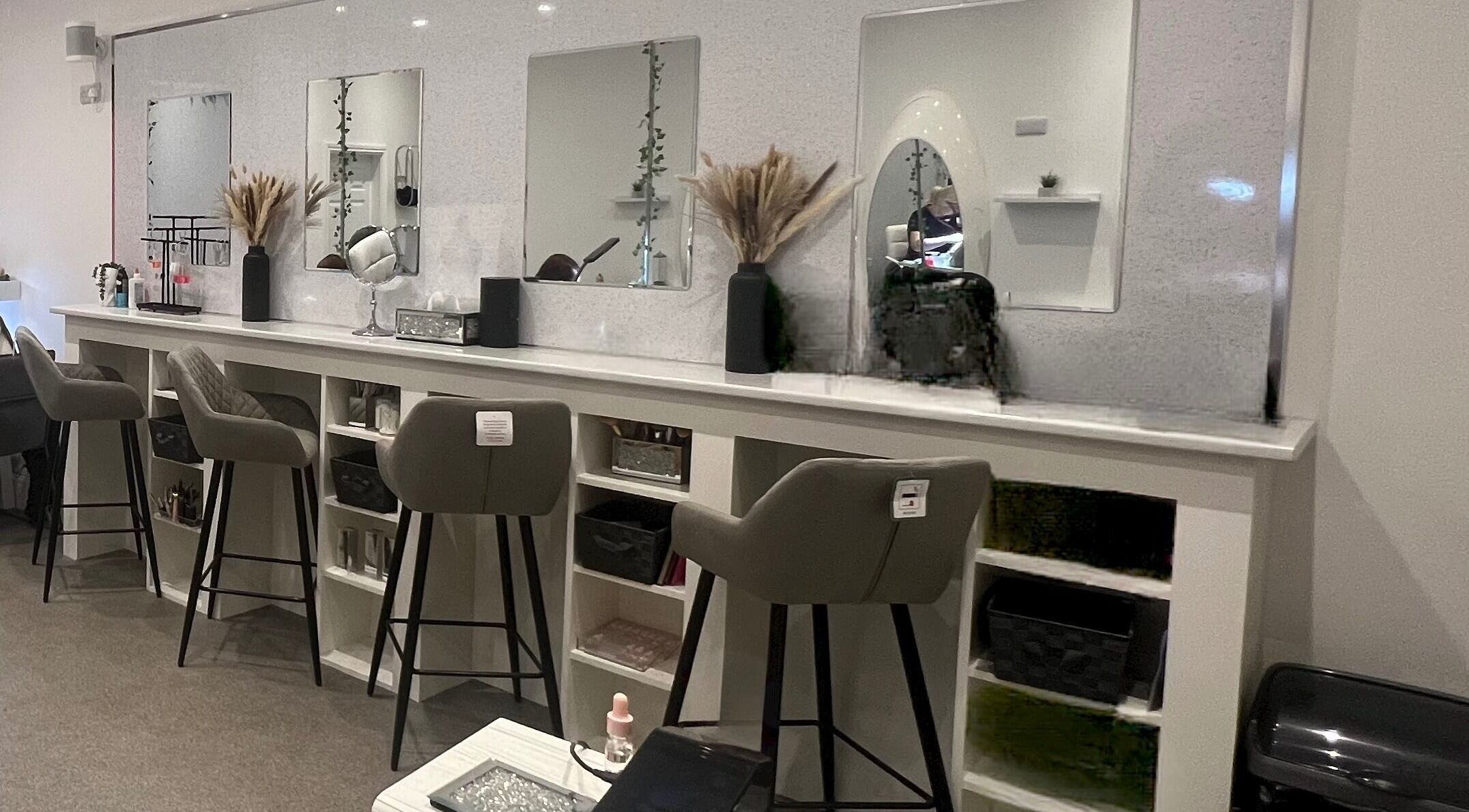 Chic beauty stations at Elysium Beauty Limited, Castletown, GB, featuring stylish mirrors and plush seating.
