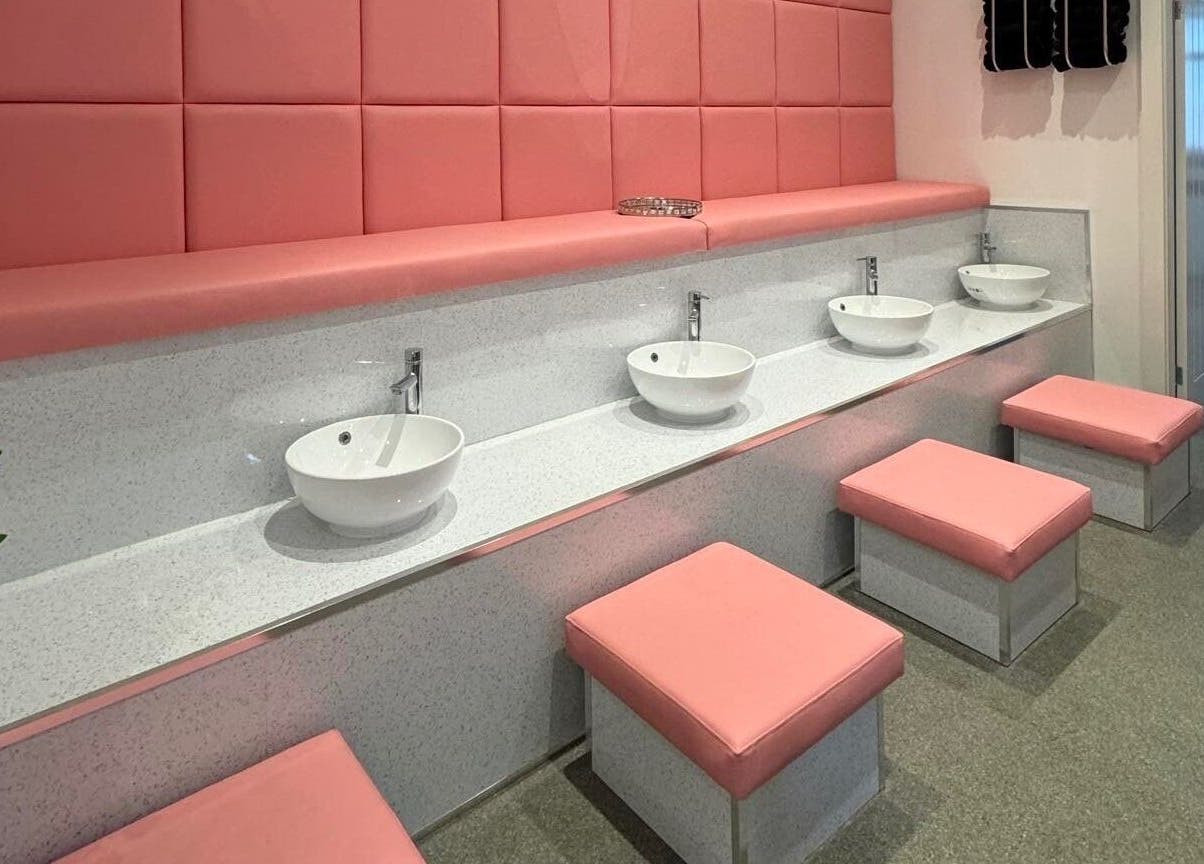 Stylish wash area with pink seating at Elysium Beauty Limited in Castletown, GB.