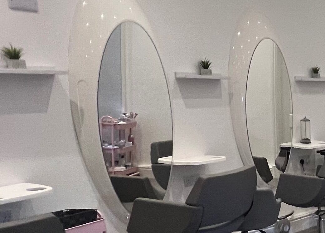 Modern salon stations at Elysium Beauty Limited, Castletown, GB with sleek mirrors and stylish chairs.